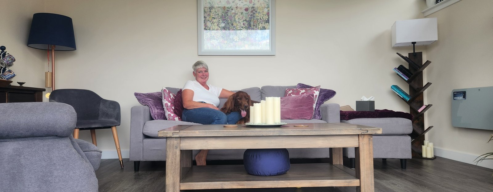 Inside the garden room where in-person sessions take place, with Wendy and her dog on the sofa